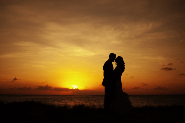 photo by Dallas wedding photographers Poser Image - the happy couple silhouetted against the sunset